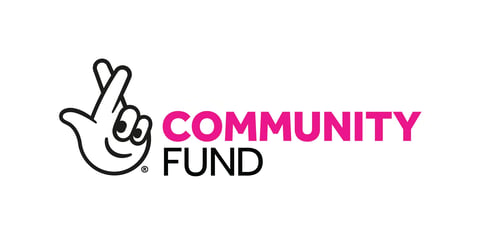 Community Fund logo with a hand making a peace sign gesture and text reading Community Fund
